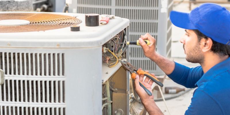 Technician repairing an air conditioning unit